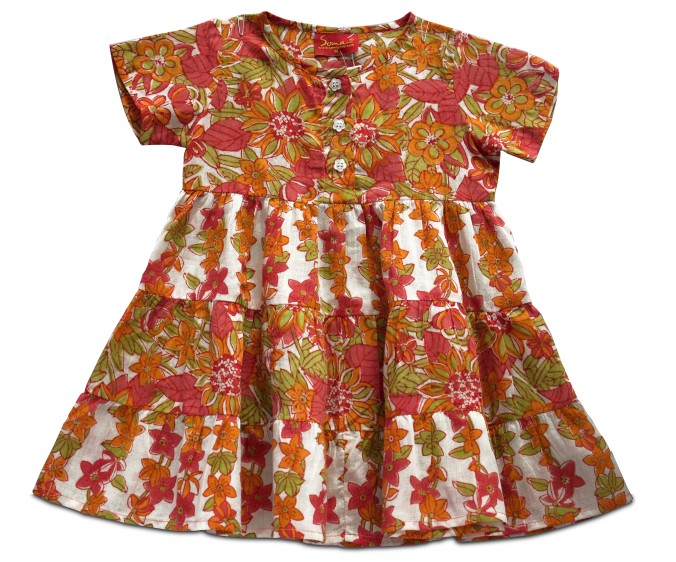 With splashes of red, orange and green on a white cotton hand block printed frock
