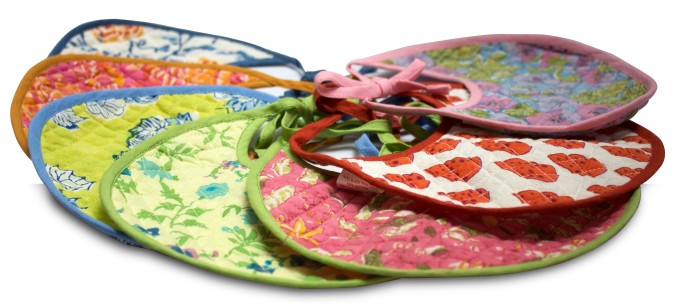 Assorted colourful bibs in cotton and hand-block printed