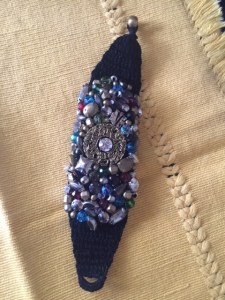 bracelet encrusted with stones, beads and metal
